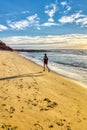Man running in the beach at dawn soft waveÃ¢â¬â¢s bright blue sky, foot prints trace in sand
